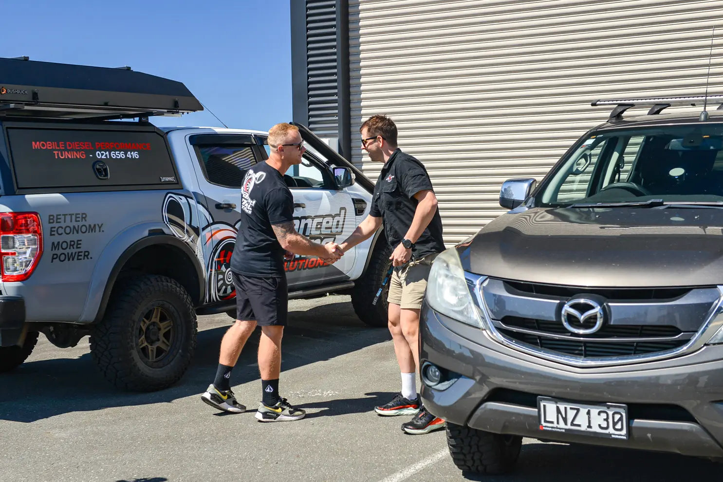 Dave going through the job with a customer beside the vehicle