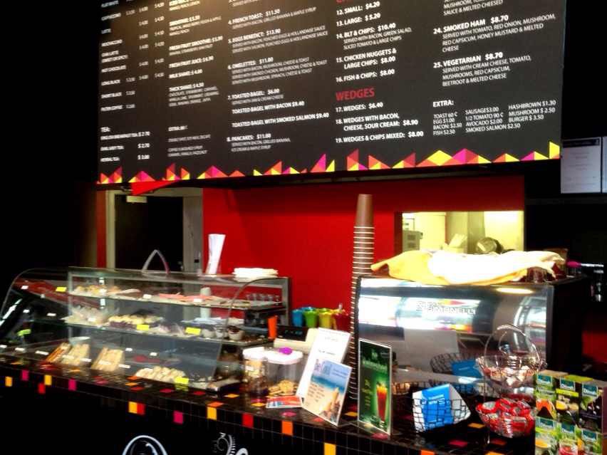 Cafe counter with menu boards and printed panels