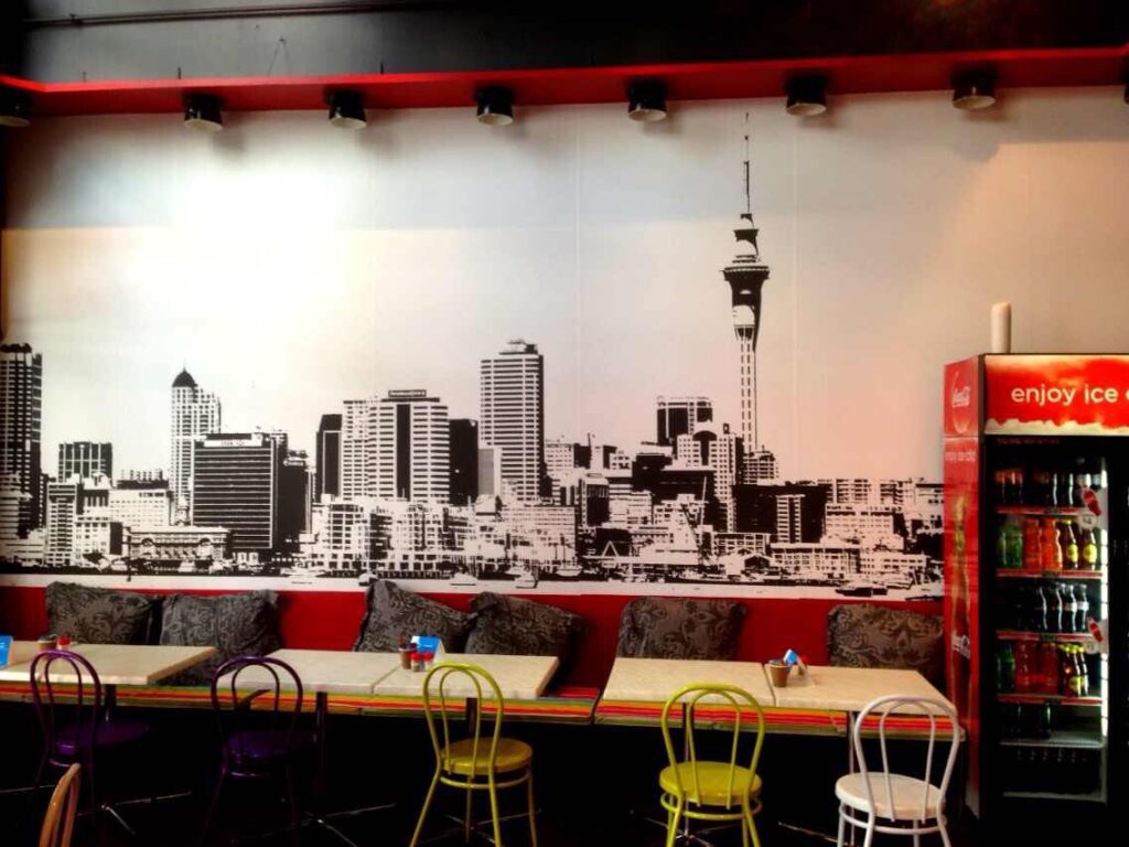 Cafe interior with a printed city skyline mural