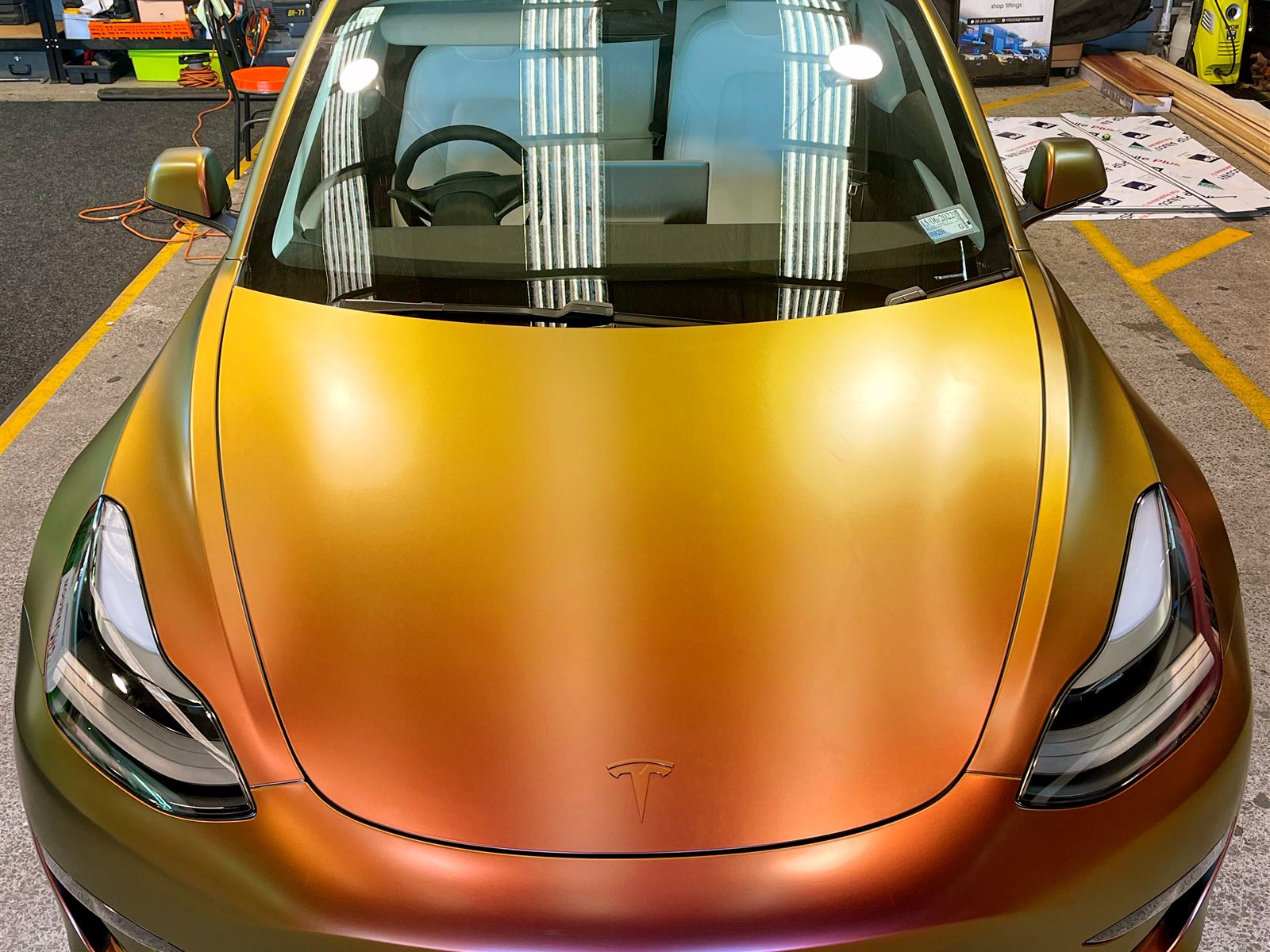Car in a colour shift wrap, seen from the front