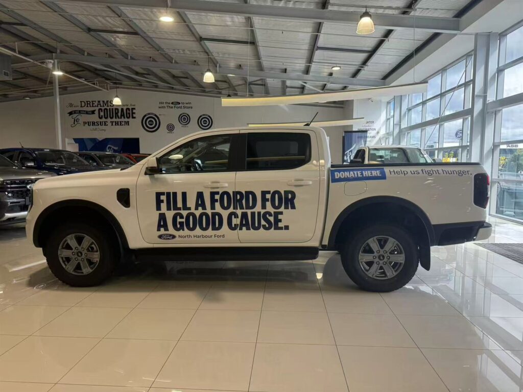 Ute with bold cut vinyl graphics in a showroom