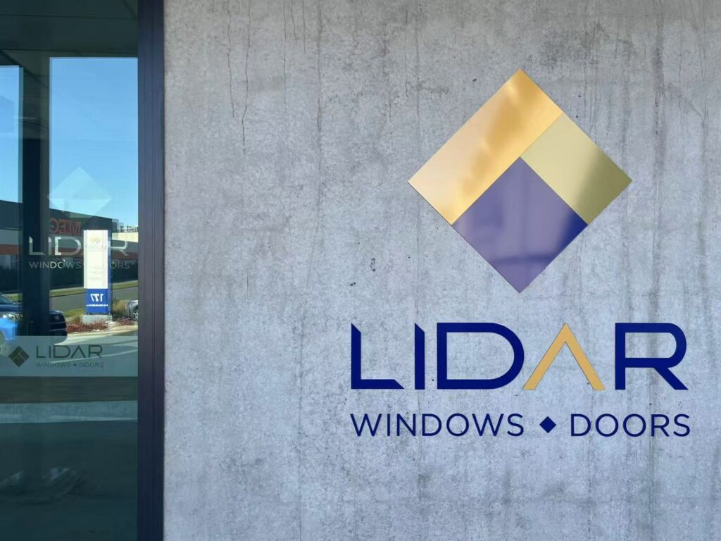 Company logo panel mounted on a concrete wall