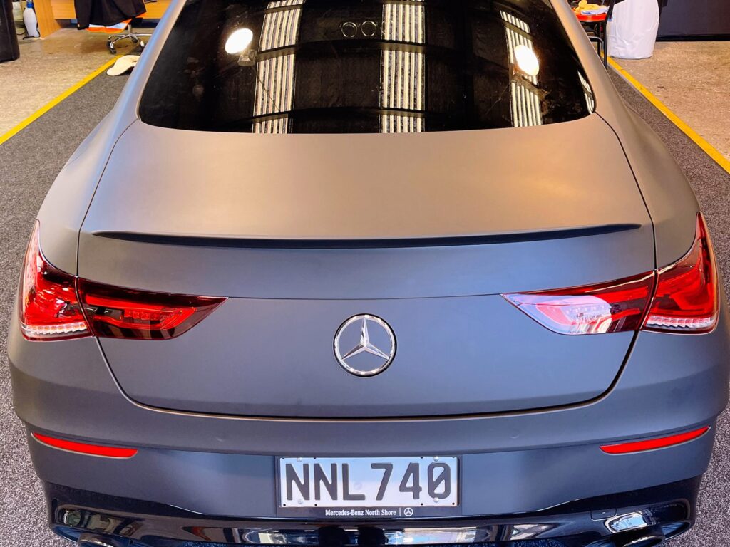 Coupe in a matte grey wrap, seen from the rear