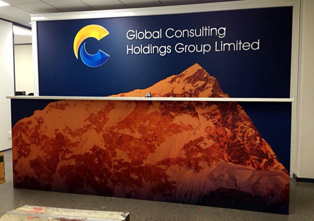 Office reception with a printed feature counter and logo wall