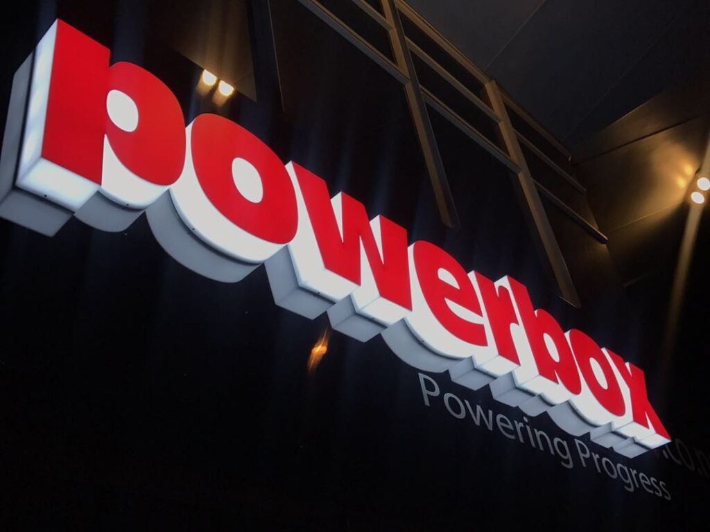 Red raised letters on a dark building facade