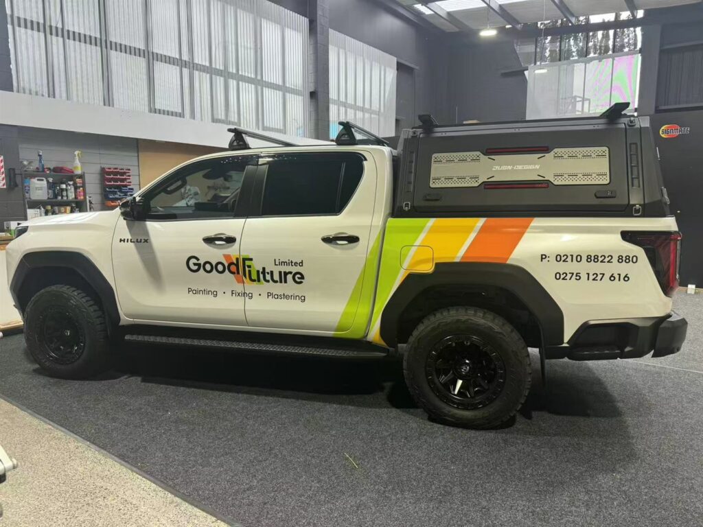 Double cab ute with door lettering and a stripe livery