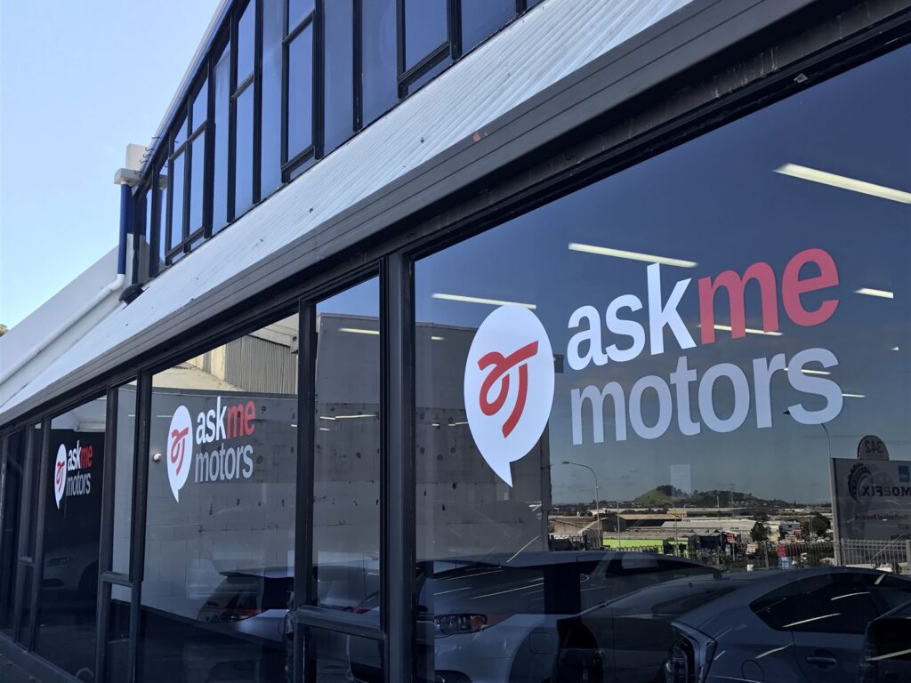 Logo window graphics across a car showroom frontage